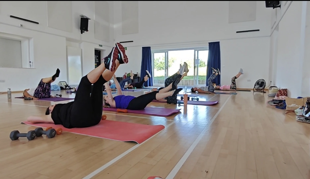Participants exercising on mats in an EmFit CoreFit class