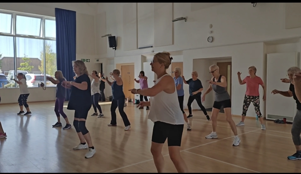 Participants moving together in an EmFit DanceFit class