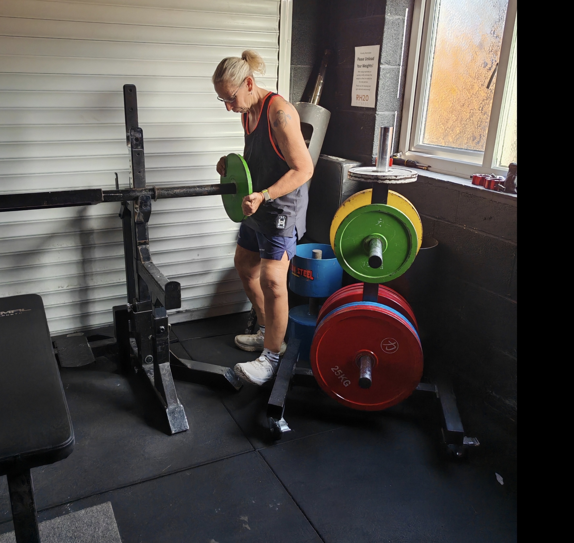 Emma setting up weights at the gym